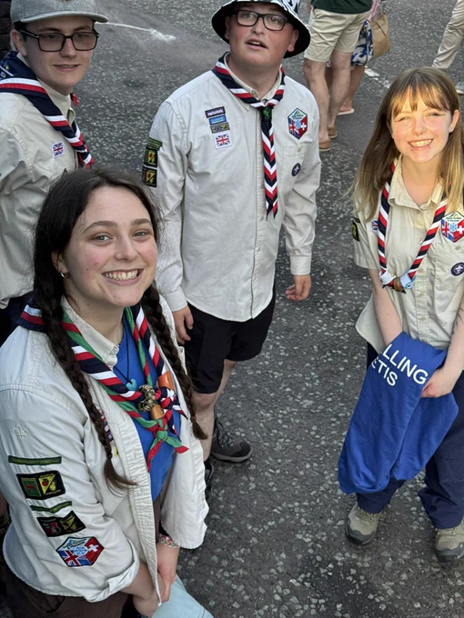 Four young adult Scout Leaders about to board the coach
