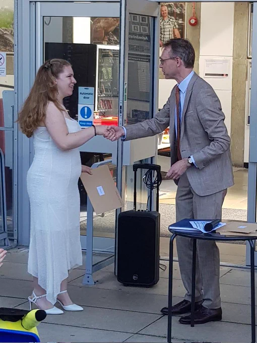 Grace Hagon receiving from Head of the Biological Sciences Department James McEvoy the Contribution to Biosciences Prize 