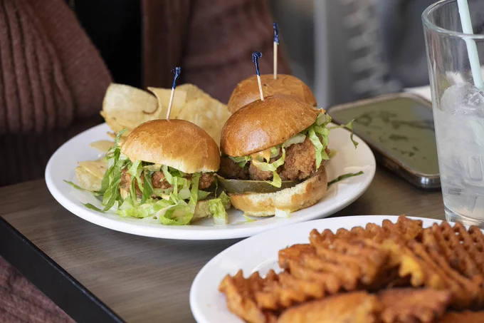 Burger and fries on plates on a table