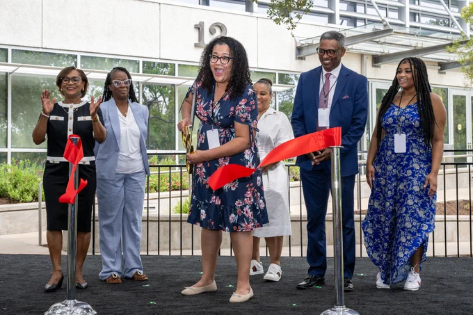 A member of Dorothy Vaughan's family participates in a ribbon cutting ceremony for the newly named Building 12 at NASA's Johnson Space Center. Credit: NASA/David DeHoyos