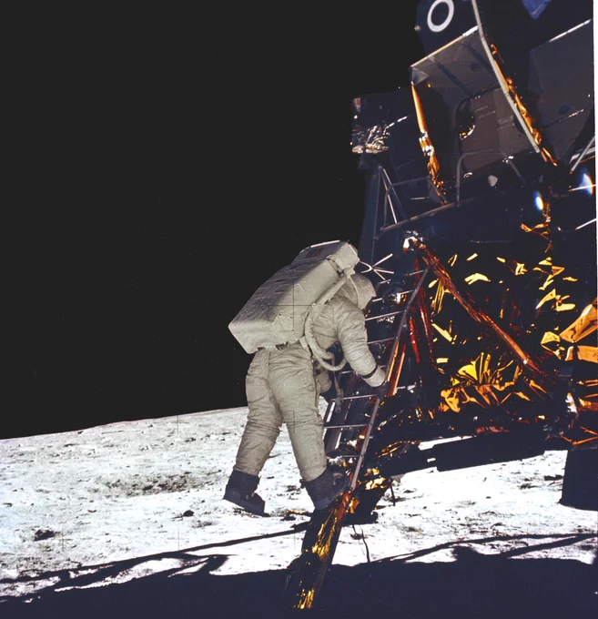Astronaut Buzz Aldrin takes his first step onto the surface of the Moon.