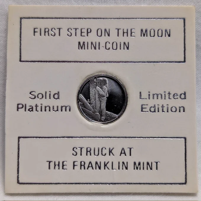 A coin card that holds the 1 g solid Platinum coin issued by the Franklin Mint in 1969 to commemorate the first step on the moon.