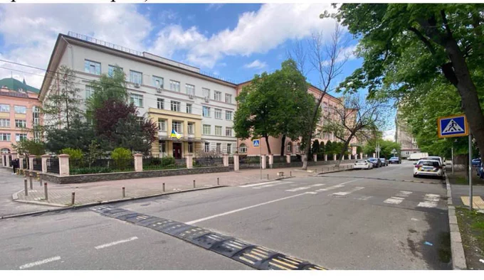 Exterior of school building in Ukraine with speed bumps and pedestrian crossing