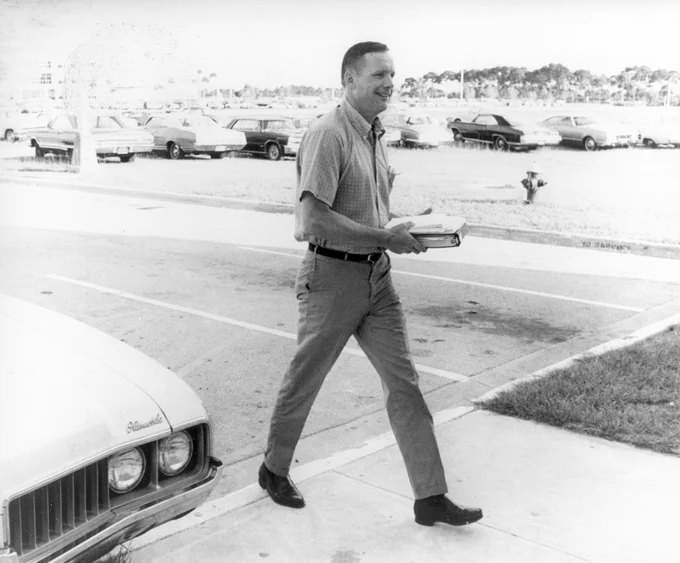 Apollo 11 astronaut Neil Armstrong carries a binder and papers as he walks from the parking lot to the flight crew training building at the NASA Kennedy Space Center (KSC) in Florida, one week before the nation’s first lunar landing mission.