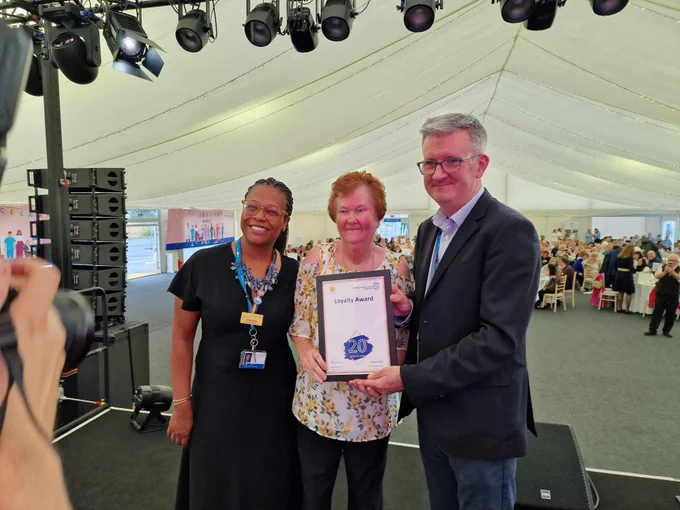 Matthew Trainer and Janine La Rosa giving certificate to member of staff