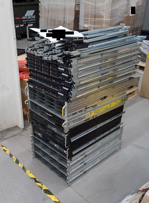 Photo show a rough stack of old 1U, 2U and 3U servers. The servers are waiting WEEE recycling collection.