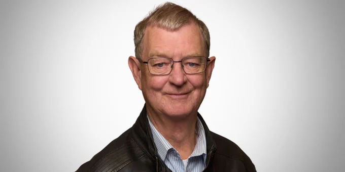 Peter Gamwell wearing glasses and smiling at the camera