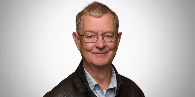 Peter Gamwell wearing glasses and smiling at the camera