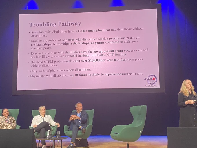 Lisa Meeks speaking on the right side of the screen; three panel members visible sitting in green chairs, screen in background has a slide titled ‘troubling pathway’ describing the fact physicians with disabilities are 10 times as likely to experience mistreatment, alongside statistics on reduced grant funding and higher unemployment rates.