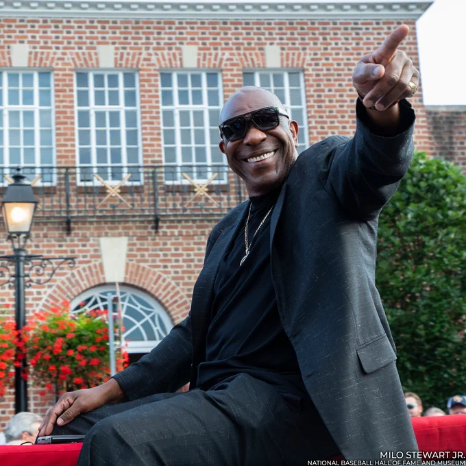 Andre Dawson smiles and acknowledges fans as he rides in the Parade of Legends outside the Hall of Fame. (Milo Stewart Jr./National Baseball Hall of Fame and Museum)