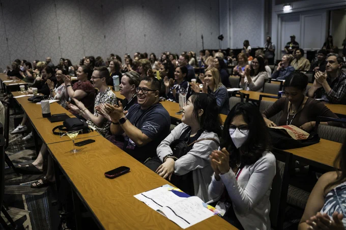 Attendees cheering on a Three Minutes Max presenter