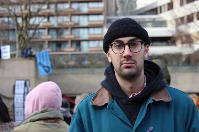 EIDGE Coordinator Aaron Bailey looks at the camera while attending a Drug User Liberation Front rally in front of the provincial courts in January, 2024. 