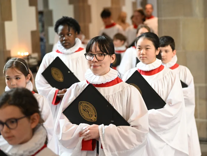 Members of a choir walking in a cathedral