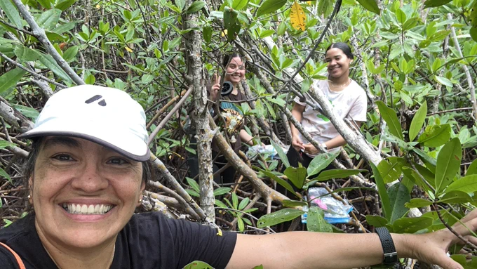 A selfie of Maria and two students in the magroves. 