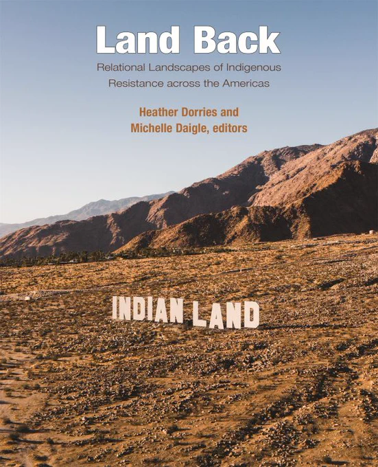 Land Back book cover. Mountain landscape with Indian Land signage.