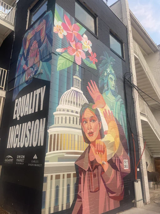 Mural depicts woman in front of the US Capitol near white text spelling "EQUITY" and "INCLUSION"