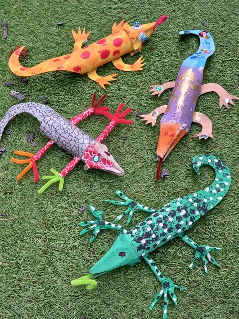 Painted and decorated cardboard lizards