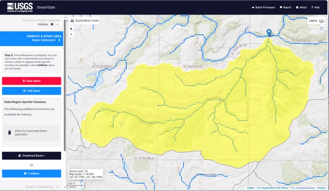 A screen capture of a web mapping application. On the left side are workflow buttons. In the main panel is a watershed highlighted in yellow. Water flows from south to north. The outlet is marked with a blue pin flag. The basin is shaped like a kitten playfully lying on its back 