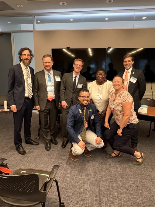 The seven panelists pose for a picture after presenting on modeling for smart, sustainable growth at the Transportation and Climate Symposium hosted by US DOT