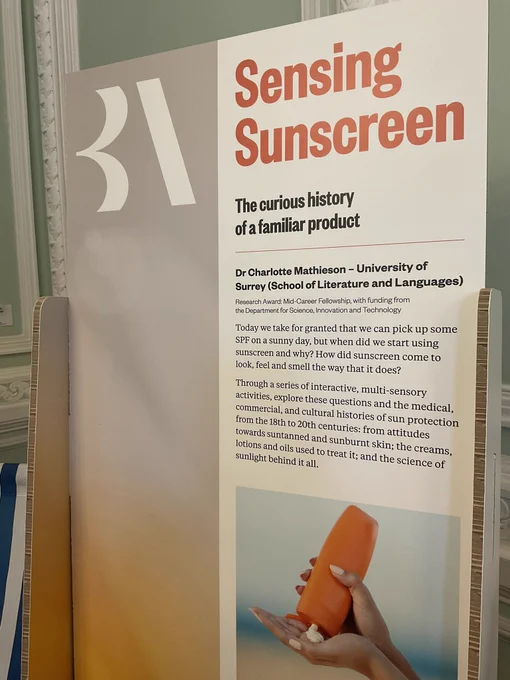 Board with words about sunscreen and picture of organs bottle of sunscreen