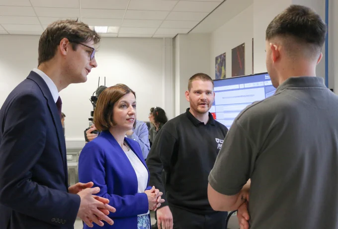 A photo of Bridget Phillipson, Tom Hunt, an apprentice and an apprenticeship tutor at the AMRC Training Centre