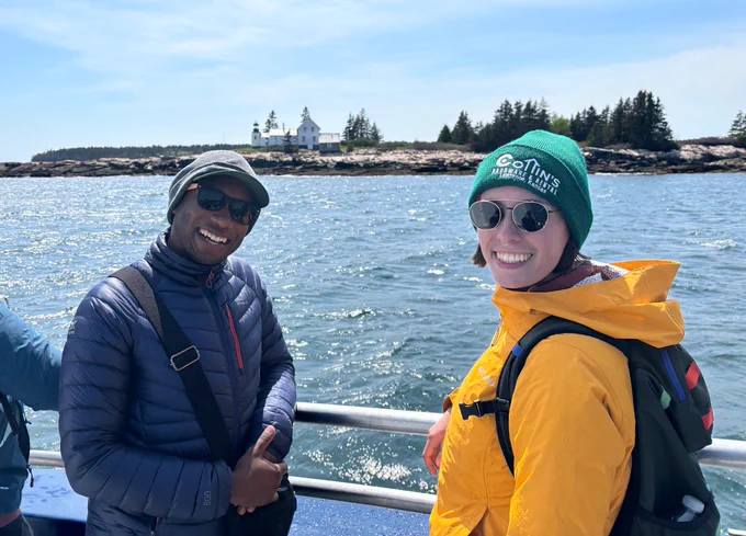 Fellows smiling on a puffin cruise during a Smith retreat