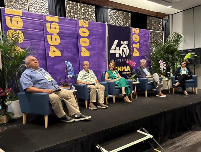 Five founders of NAHJ sitting in chairs on stage with microphones in their hands