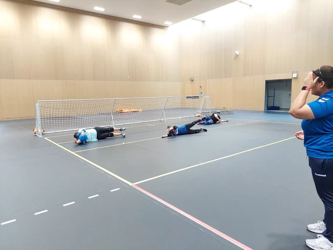 Alex Ulysses stood on the right side of the photo watching on as the 3 players on court dived to save the ball during a drill.