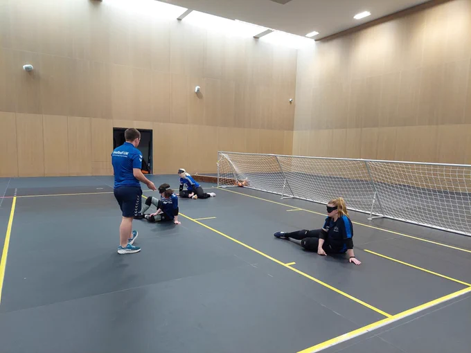I’m on the other side of the court with 3 other players doing the same drill. I’m standing in front of the 3 players giving some feedback after practicing the skills we were working on.