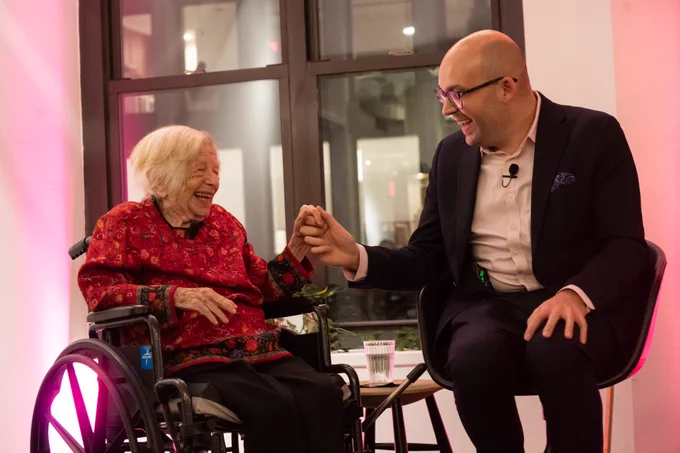 Kinsey Institute Director Dr. Justin Garcia holds hands with Dr. Ruth at a Kinsey Institute event honoring her work in NYC January 2024. 