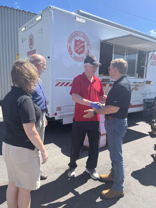 Premier Furey, MHA Perry Trimper and Minister Lisa Dempster speaking to a volunteer.