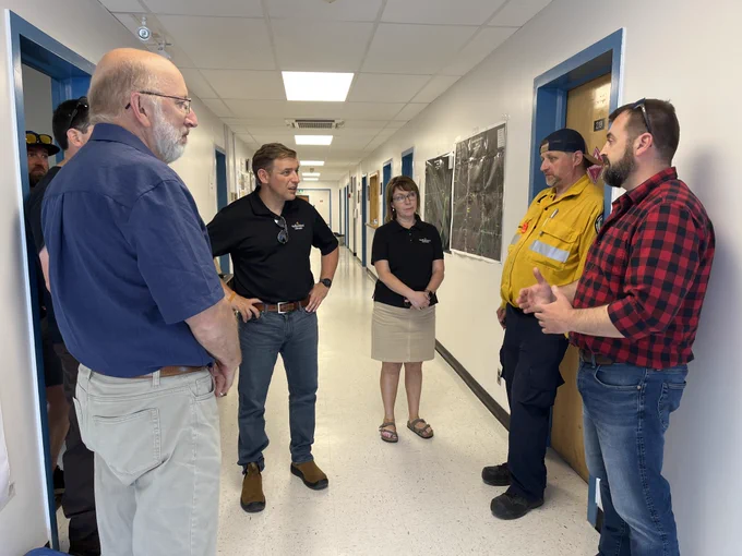 Premier Furey, MHA Perry Trimper and Minister Lisa Dempster speaking with Forestry officials.