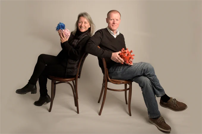  Dr. Erica Tandori and Professor Jamie Rossjohn began the Monash Sensory Science Exhibition program in 2018 at Monash University, Australia. Erica (left) holds a T cell sculpture, made of paper-mache and wool; Jamie (right) holds a paper-mache rotavirus model.