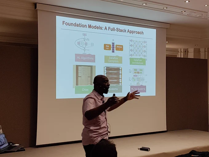 Kunle Olukotun giving keynote talk in front of slide at #ACACES24