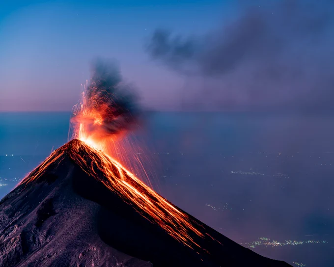 An erupting volcano at dusk