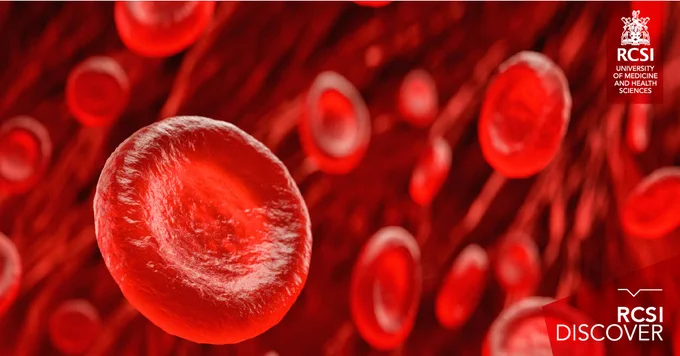 The image shows a close-up, detailed view of red blood cells flowing through blood vessels. The cells are depicted in various sizes and perspectives, creating a sense of depth. The background is a deep red, enhancing the focus on the vibrant, disc-shaped red blood cells. The RCSI logo is visible in the top right corner, along with the text "RCSI University of Medicine and Health Sciences." The bottom right corner features the text "RCSI DISCOVER" 