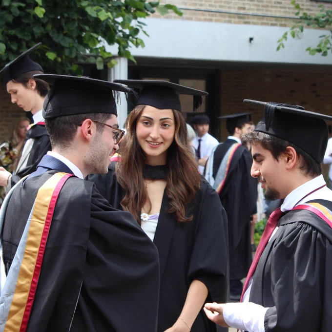 Graduating students talk outside the Great Hall