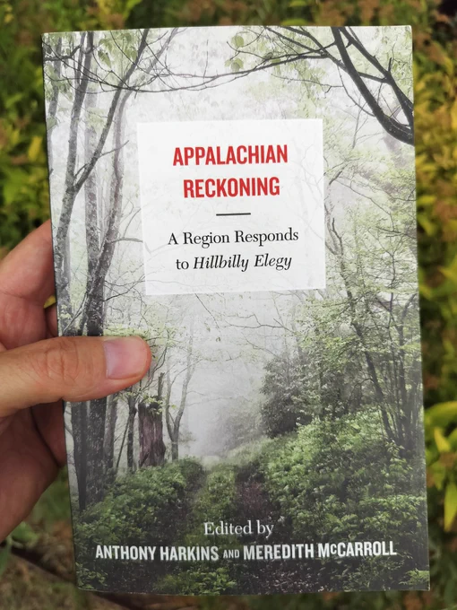 A book with a cover of a trail in a wood