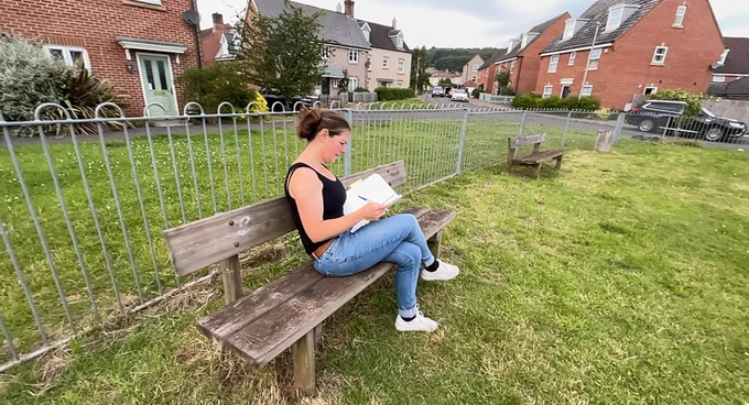 On a bench, proofreading