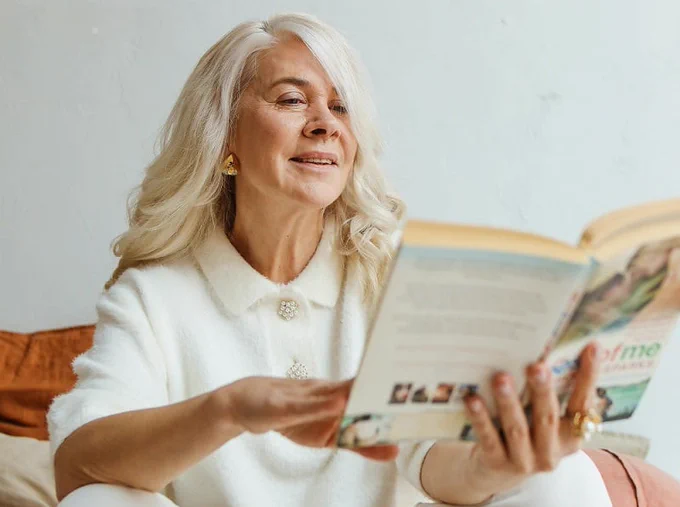 An image of a woman reading a book.