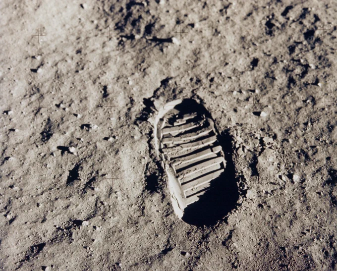A bootprint on the Moon, made by American astronaut Buzz Aldrin during the Apollo 11 mission. The Moon's bumpy, gray surface stands out in sharp detail in this photo, as does the print, which is oval-shaped with thick lines running across its tread. Credit: NASA