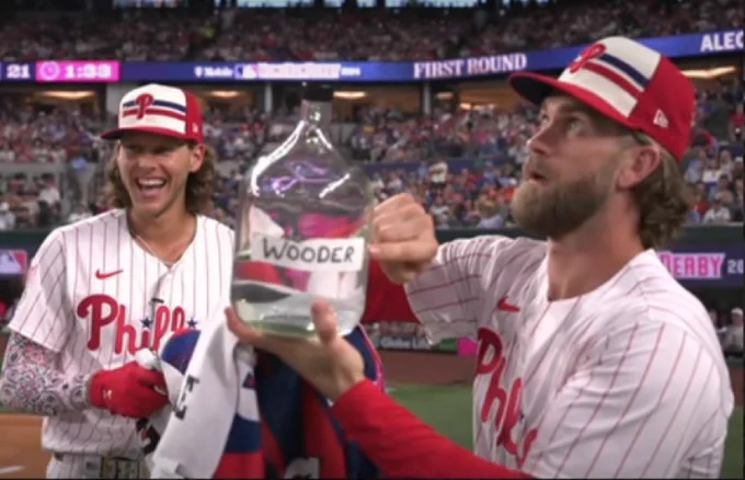Bryce Harper and Alec Bohm of the Philadelphia Phillies holding a jug of water