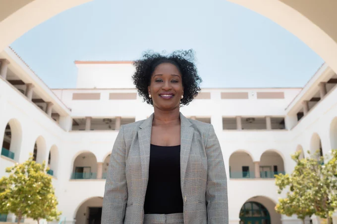 A smiling Kimberley Folkes-Dunkley on the steps of the Conrad Prebys Aztec Student Union.