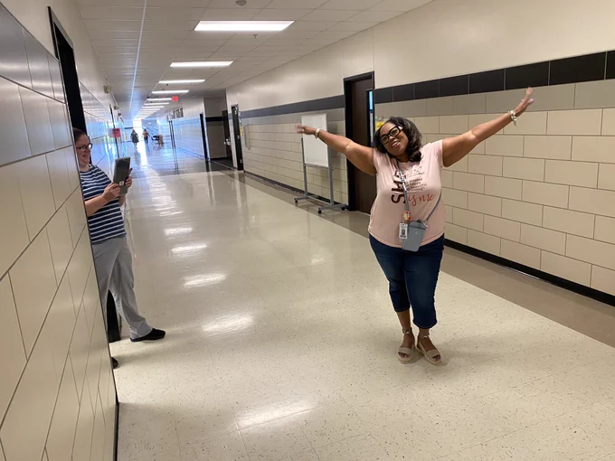 Teacher acting out the life cycle of a butterfly to complete a Goosechase mission.
