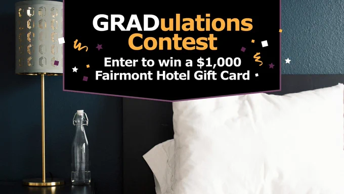 White bed with a lamp and nightstand next to it. Text "GRADulations Contest. Enter to win a $1,000 fairmont hotel gift card." 
