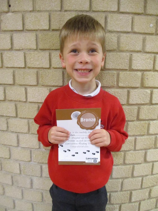 child smiling holding certificate