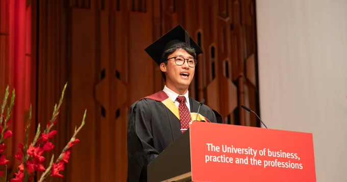 A photo of  Donghyun Nam reading his speech at a podium