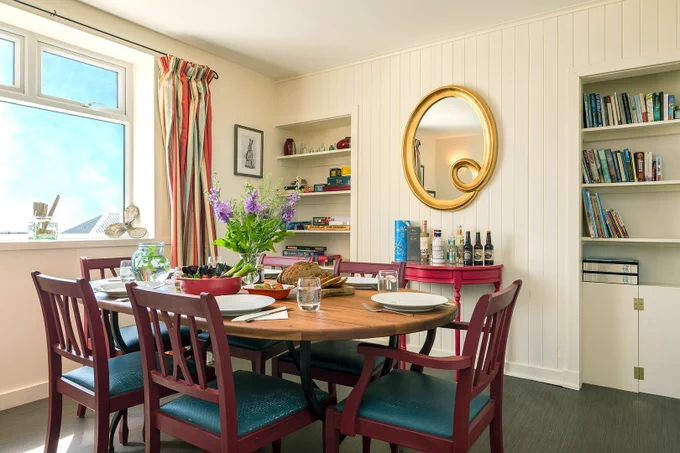 The dining room at the Lighthouse Keepers Cottage with the table laid for eating