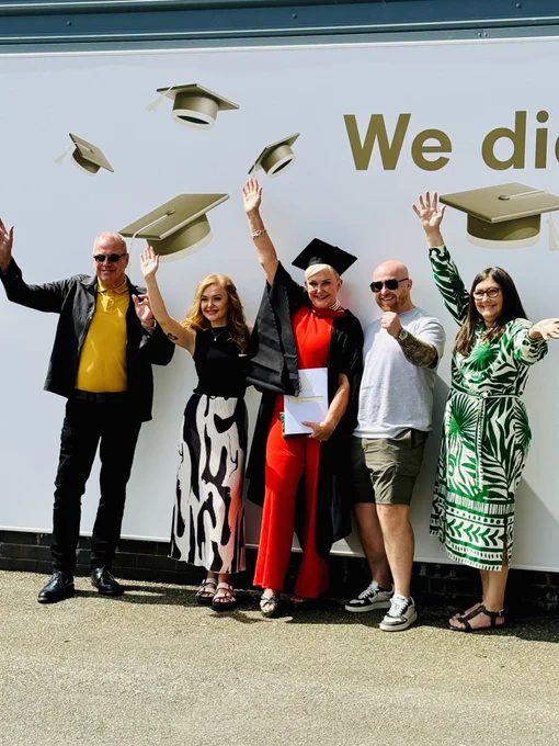 A graduate and their guests smiling for a photo.