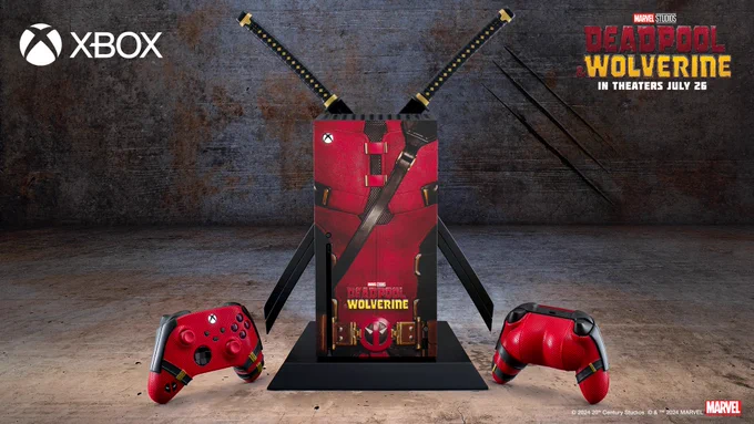 Image of a custom ‘Deadpool & Wolverine’ Xbox Series X console with two katanas attached to the backside and a Deadpool-themed covering, set in an industrial scene. Two Deadpool-themed controllers flank the console: one facing forward and the other backward, revealing a cushion shaped like Deadpool’s buttocks attached to it. The Xbox logo is visible in the bottom left, and the ‘Marvel Studios Deadpool & Wolverine’ logo along with text reading “in theaters July 26” is in the bottom right corner. In the middle, there is text reading “© 2024 20th Century Studios ©&™ 2024 MARVEL” next to the Marvel logo.